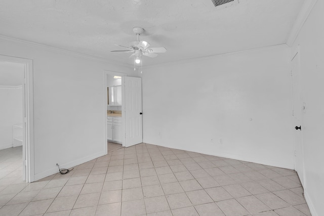 tiled empty room with ceiling fan and ornamental molding