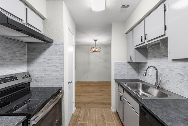 kitchen with white cabinetry, sink, extractor fan, decorative backsplash, and appliances with stainless steel finishes