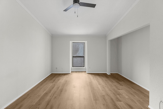 empty room featuring lofted ceiling, light hardwood / wood-style floors, ceiling fan, and ornamental molding