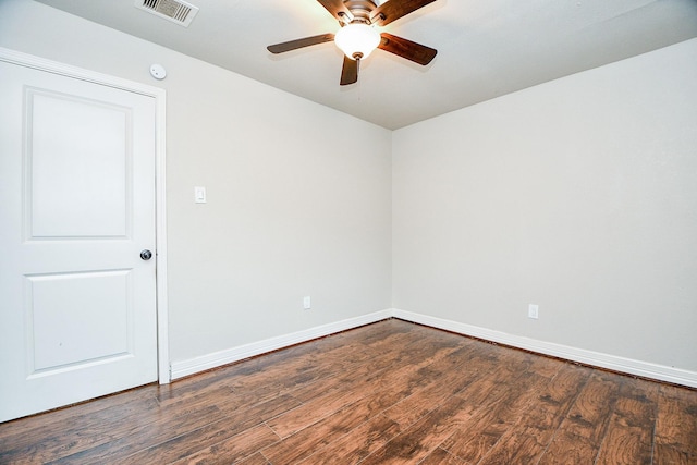 unfurnished room with ceiling fan and dark hardwood / wood-style flooring