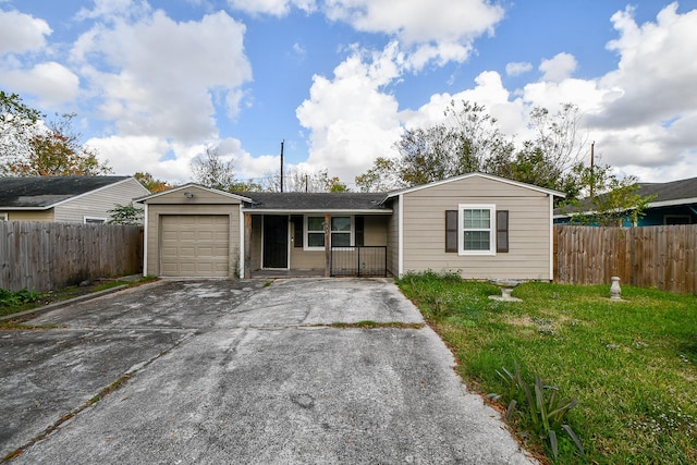 ranch-style house with a garage and a front lawn