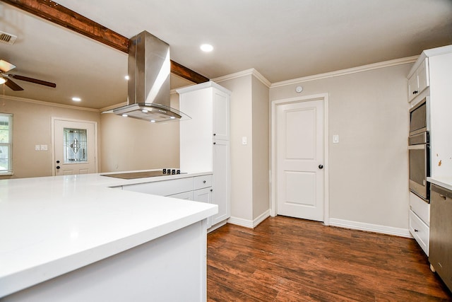 kitchen with wall chimney exhaust hood, dark hardwood / wood-style floors, kitchen peninsula, white cabinets, and appliances with stainless steel finishes