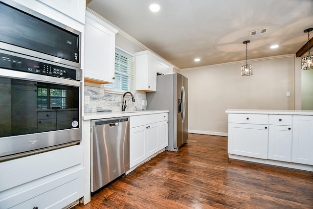 kitchen featuring white cabinetry, dark wood-type flooring, pendant lighting, and appliances with stainless steel finishes