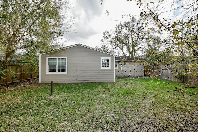 rear view of property featuring a lawn