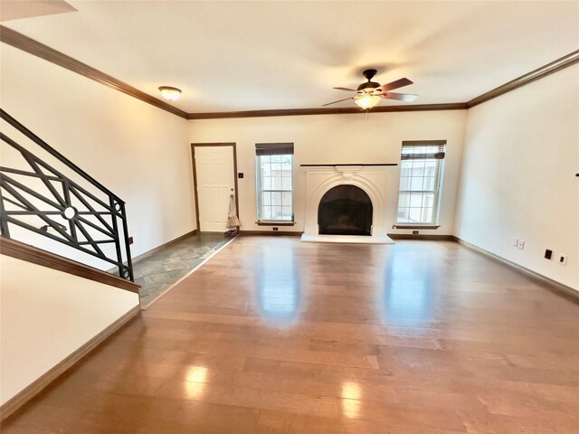 unfurnished living room with ceiling fan, wood-type flooring, and crown molding