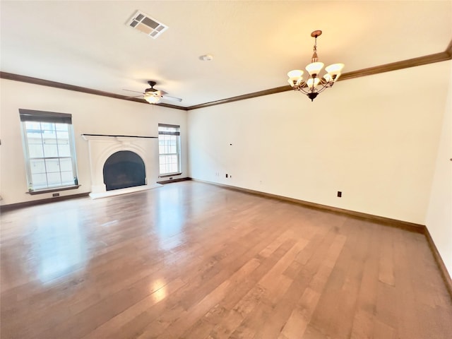 unfurnished living room featuring wood-type flooring, ceiling fan with notable chandelier, and ornamental molding