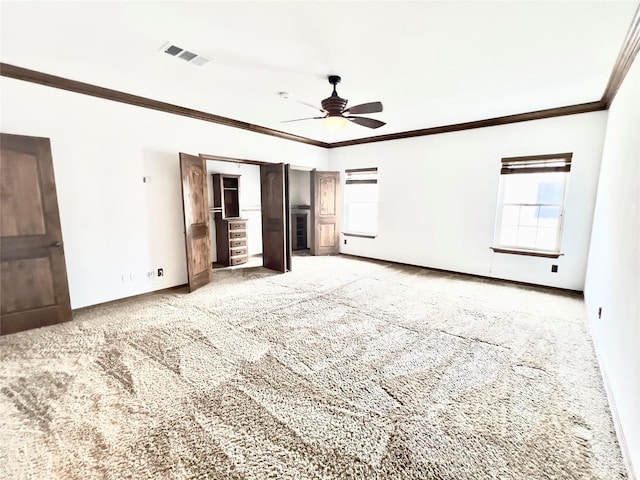 unfurnished bedroom with carpet flooring, ceiling fan, and ornamental molding