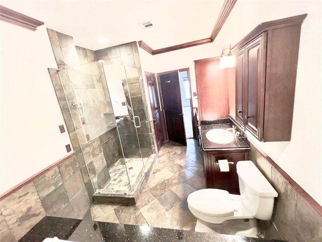 bathroom with vanity, toilet, ornamental molding, tile walls, and an enclosed shower