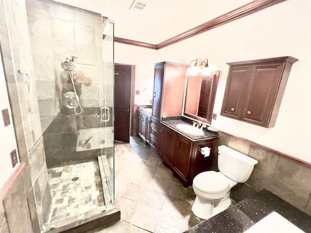 bathroom featuring vanity, toilet, ornamental molding, tile walls, and an enclosed shower