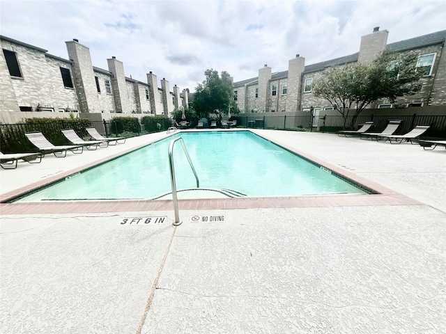 view of swimming pool featuring a patio area