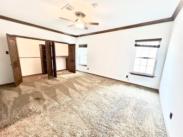 unfurnished bedroom with multiple windows, light carpet, ceiling fan, and ornamental molding