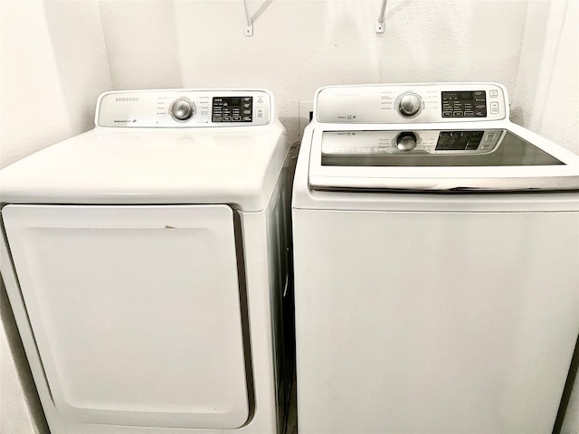 clothes washing area with independent washer and dryer