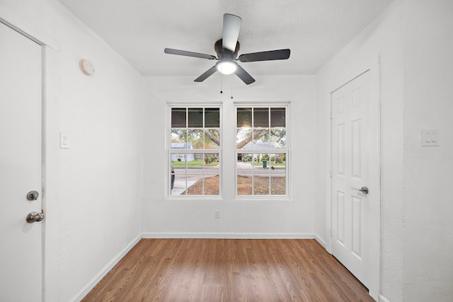 unfurnished room featuring ceiling fan and hardwood / wood-style floors