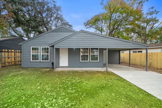 view of front of property featuring a carport and a front lawn