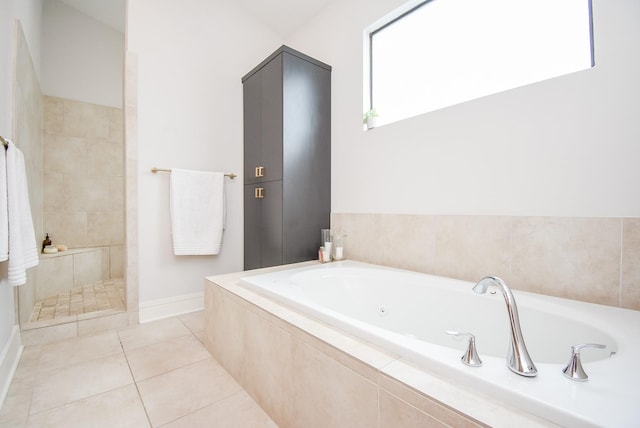 bathroom featuring tile patterned flooring and separate shower and tub