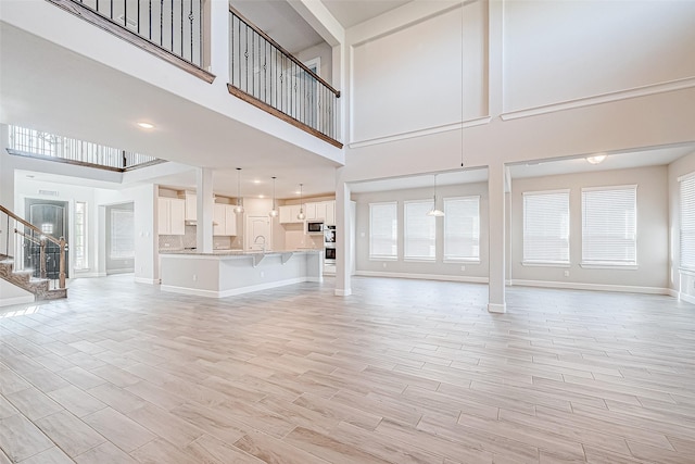 unfurnished living room with a high ceiling