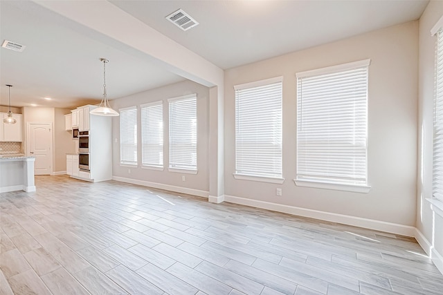 unfurnished living room with light wood-type flooring