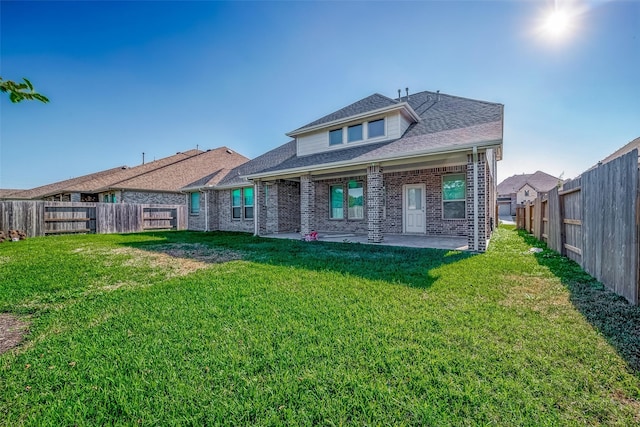 back of property featuring a yard and a patio