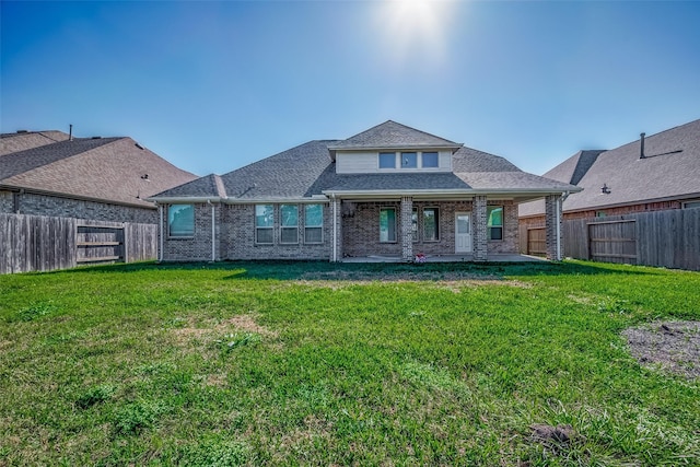 rear view of property featuring a patio area and a lawn