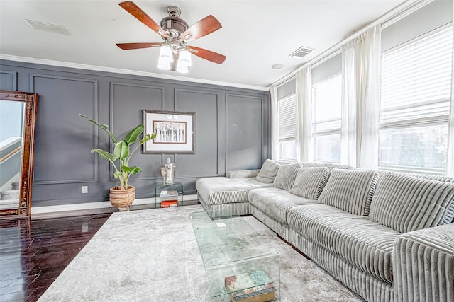 living room with ceiling fan, dark hardwood / wood-style flooring, and ornamental molding