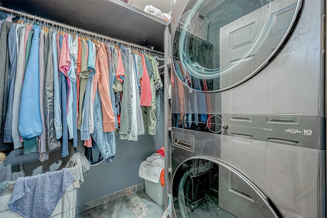 clothes washing area with stacked washer and clothes dryer