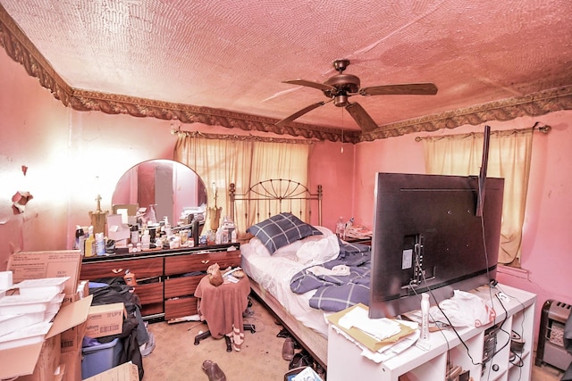 bedroom featuring carpet flooring, a textured ceiling, heating unit, and ceiling fan