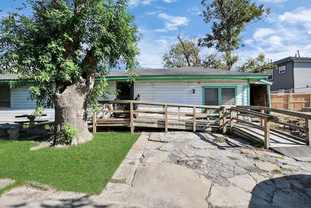 back of property featuring a wooden deck