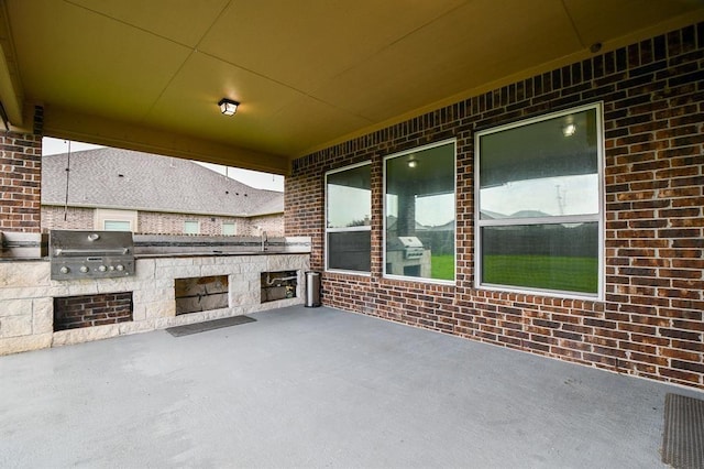 view of patio with area for grilling, exterior kitchen, and sink