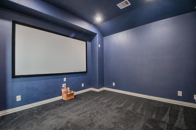 carpeted home theater featuring lofted ceiling