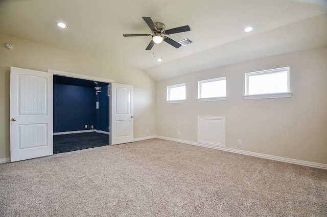 unfurnished bedroom with carpet floors, vaulted ceiling, and ceiling fan