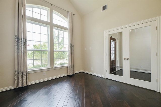 unfurnished room with vaulted ceiling, french doors, and dark hardwood / wood-style floors