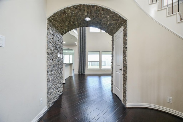 hallway with dark hardwood / wood-style flooring