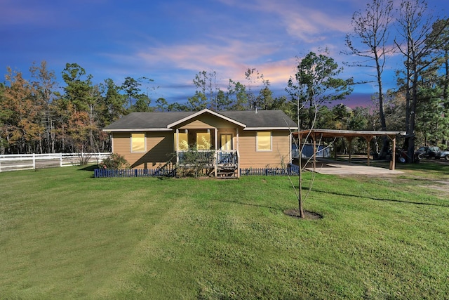 view of front of home featuring a carport and a lawn