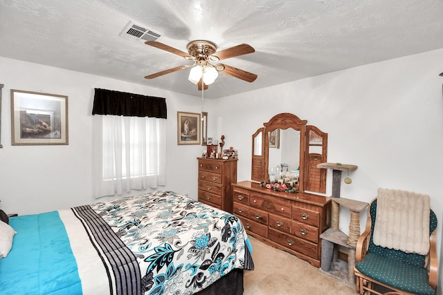 bedroom with light carpet, a textured ceiling, and ceiling fan