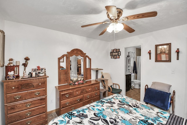 bedroom with ceiling fan and ensuite bath