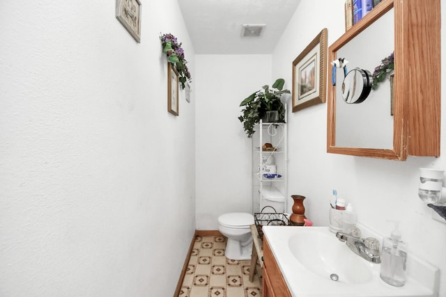 bathroom with vanity and toilet