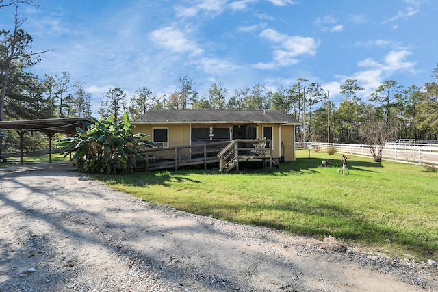 view of front facade featuring a carport and a front yard