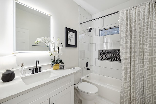 full bathroom featuring toilet, vanity, and tiled shower / bath