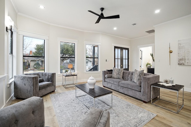 living room with ceiling fan, light hardwood / wood-style floors, and ornamental molding