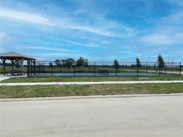 exterior space with a gazebo, a lawn, and tennis court