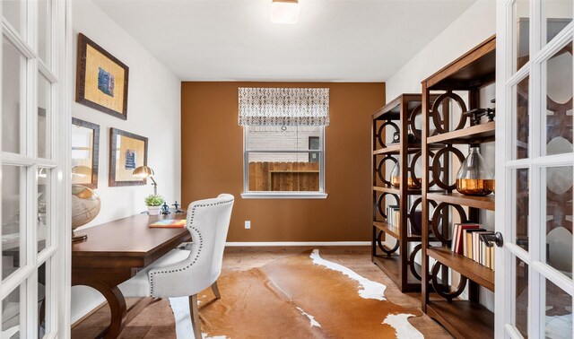 wine area featuring hardwood / wood-style floors and french doors