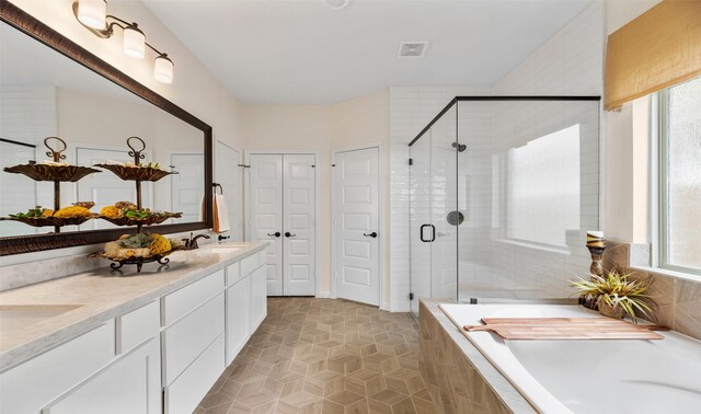 bathroom with tile patterned flooring, vanity, and independent shower and bath