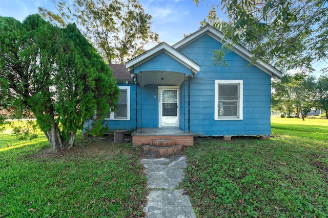 bungalow-style home featuring a front yard