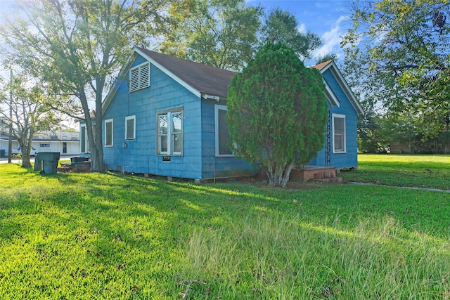 view of side of home featuring a lawn