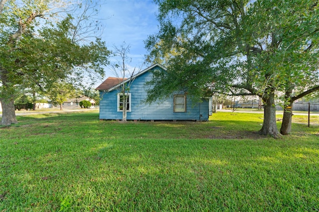 view of side of home with a lawn