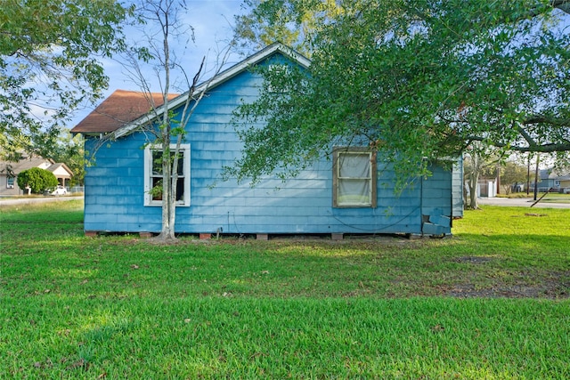 view of side of home featuring a yard