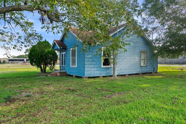 view of home's exterior with a yard