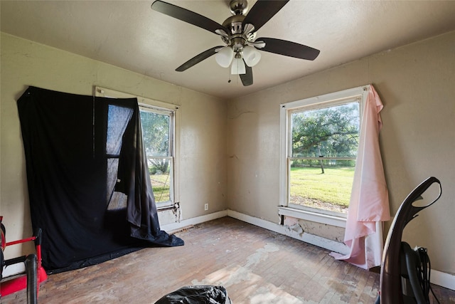 interior space with hardwood / wood-style flooring, ceiling fan, and a wealth of natural light