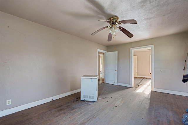 interior space featuring hardwood / wood-style floors, ceiling fan, and a textured ceiling