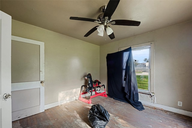 misc room featuring ceiling fan and dark wood-type flooring